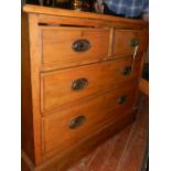 An early 20th century pine chest of drawers, having two short over two long drawers,
