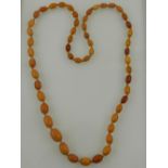 An amber necklace of graduated ovoid beads. approx. L.