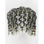 A Parisian 1920s style black and gilt beaded headpiece.