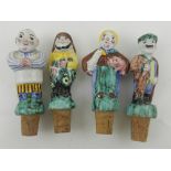 Four figural bottle stoppers.