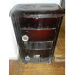 A mid 20th century wrought iron wood burning stove. H.73cm W.