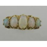 A late 19th century yellow gold five stone opal dress ring, set with five cabouchon cut opals.