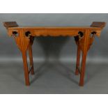 A Chinese hardwood altar table of diminutive size, with carved and shaped apron, raised on moulded