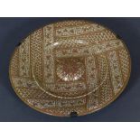 A Hispano-Moresque lustreware display charger, decorated with panels of reticulated and floral