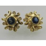 A pair of yellow metal sapphire and diamond set ear studs.