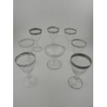 A collection of wine and champagne glasses, having etched design to bowl.