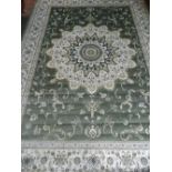 A Persian style green ground Tabriz carpet, having floral medallions to centre,