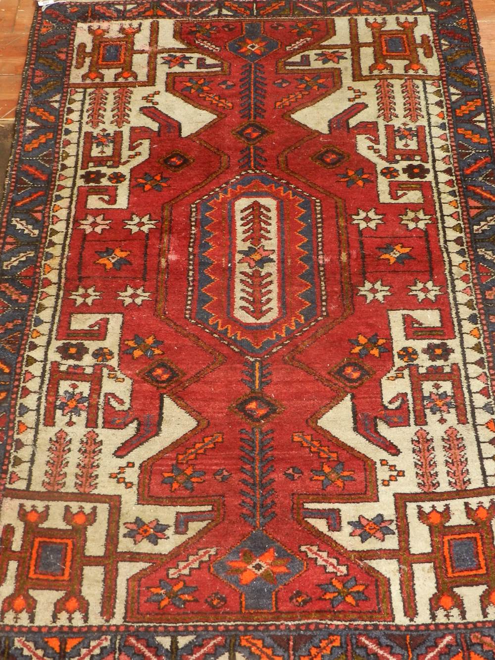 A red ground Caucasian prayer rug, of geometric design, multi-bordered and fringed, L.159cm, W.107.