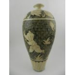 A 20th century Cizhou ware style ovoid vase, decorated with children amongst flowers and foliage. H.