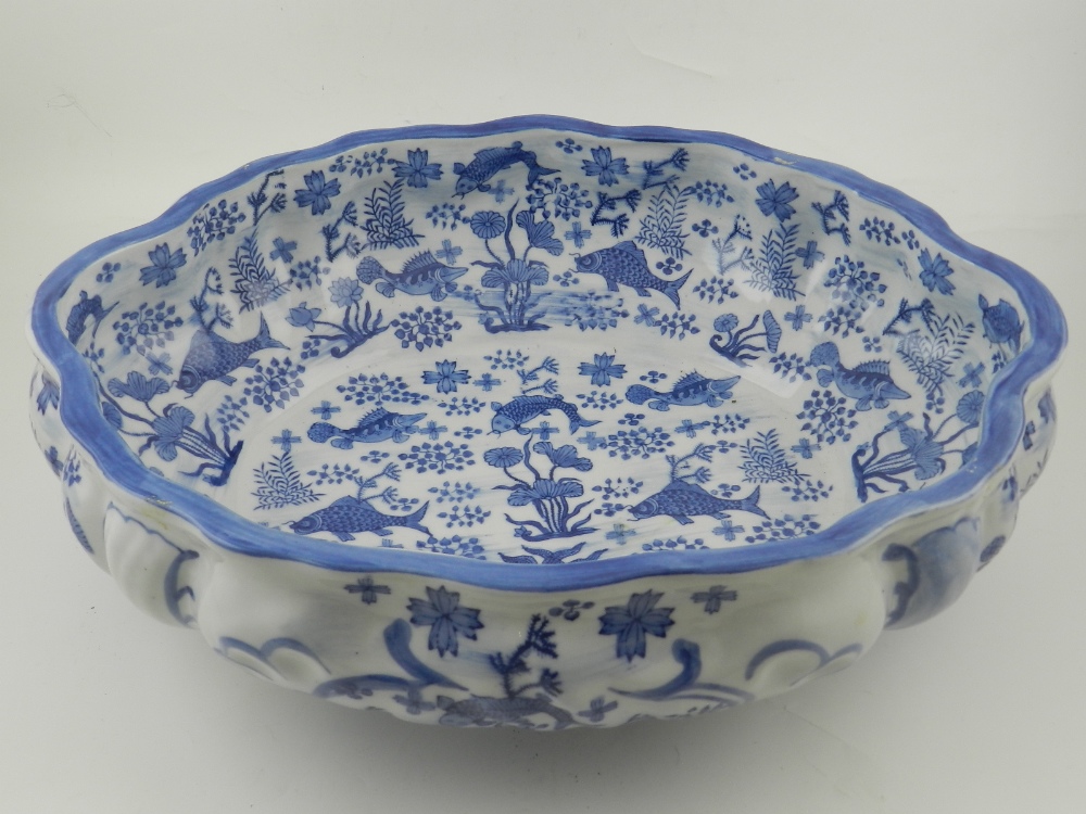 A modern Chinese blue and white porcelain fish bowl, in the 18th century taste, decorated rocaille.