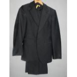 Four gentleman's black dress suits, with braided seaming.