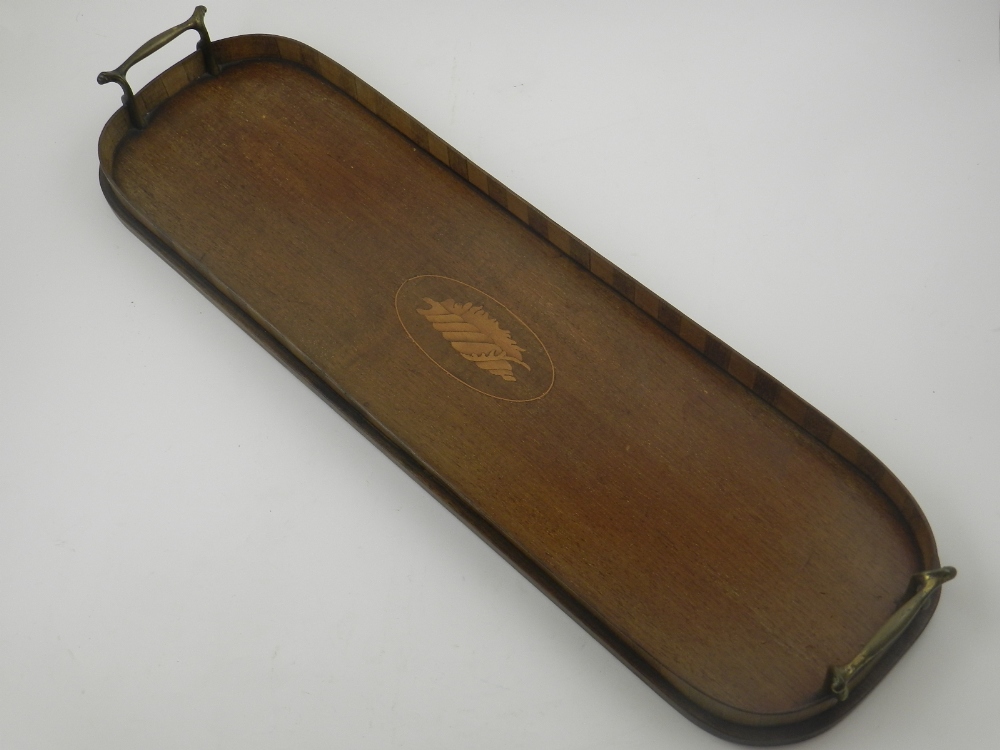 An Edwardian mahogany and boxwood oval tea tray, centred with a marquetry shell paterae,