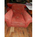 A Contemporary armchair, upholstered in red and monogrammed fabric, raised on casters.