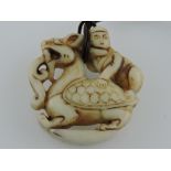 A hardstone pendant carved in the form of a young man riding a dragon, H.