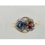 A sapphire and ruby crossover ring, the claw set stones within hoops of diamonds, on a gold band,