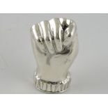 A white metal pill box in the form of a clenched fist, stamped 925, 18g.