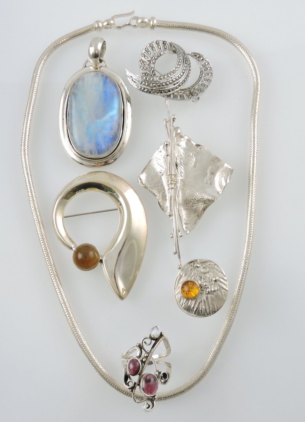 A small quantity of white metal and silver jewellery including an amber set disc ring and a large