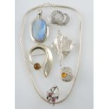 A small quantity of white metal and silver jewellery including an amber set disc ring and a large