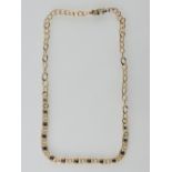 A 9ct yellow gold and sapphire necklace the 13 faceted stones rub over set in oval links, L 44 cms,