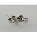 A pair of white metal and diamond ear studs,