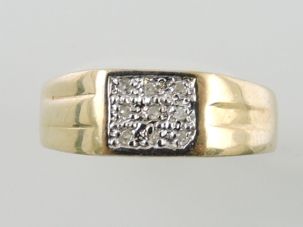 A diamond dress ring, the arrangement of nine pave set stones in a yellow metal band stamped 375,