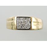 A diamond dress ring, the arrangement of nine pave set stones in a yellow metal band stamped 375,