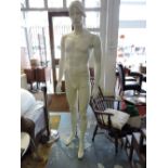 A life sized white composition male mannequin on square brass chrome stand, H. approx.