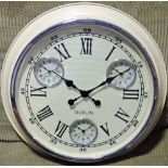 A circular chrome and cream painted wall clock,