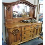An Edwardian oak mirror back sideboard the arched plate flanked by ionic baluster pillars over 3