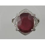 A white metal, ruby and diamond dress ring,