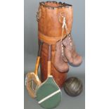 A vintage style tan leather hanging punch bag and boxing gloves together with a stitched leather