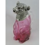 A Victorian style silver-plated and ruby glass claret jug, modelled as a seated bear,