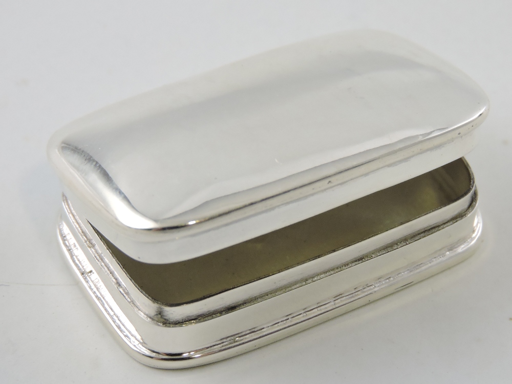 A white metal rectangular pill box, with plain domed cover, W. 4cm.