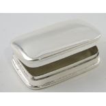 A white metal rectangular pill box, with plain domed cover, W. 4cm.