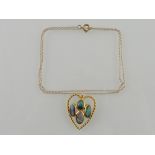 A black opal pendant, with four oval stones in a yellow metal rope-twist heart shaped setting,