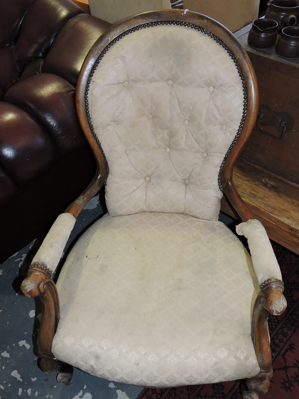 A Victorian style upholstered beech spoon back arm chair