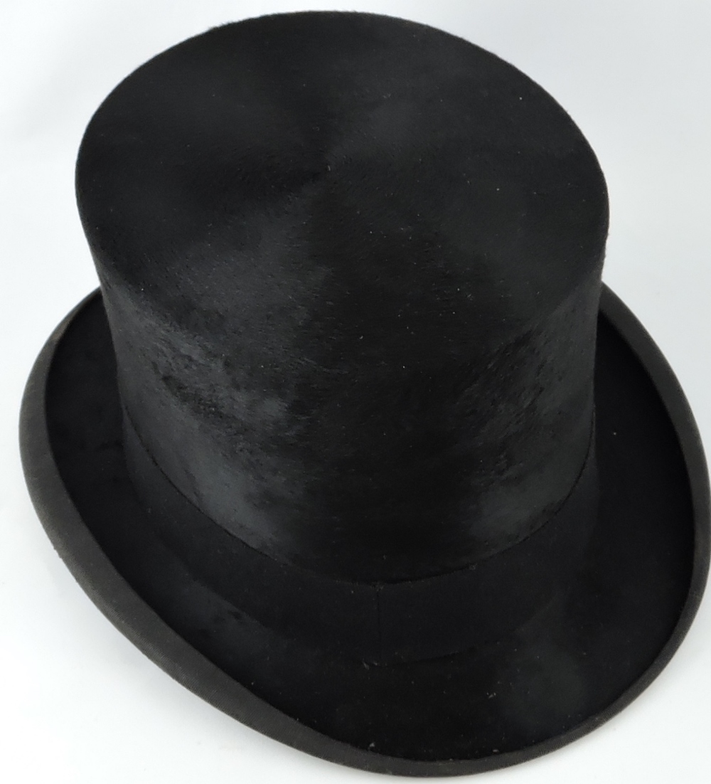 A gentleman's black silk top hat by Dunn & Co.