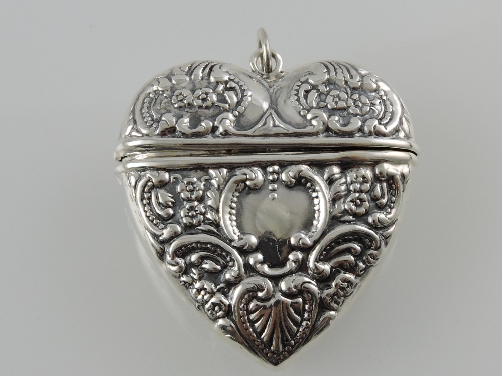 A white metal heart-shaped locket,