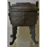A Chinese cast bronze koro with detachable cover of rectangular form on 4 scroll feet