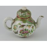 A late 19th Century Chinese Cantonese miniature teapot decorated with panels of figural and