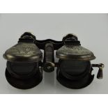 An unusual pair of opera glasses and engraved with images of Columbus landing in America.