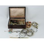A quantity of costume jewellery together with an early 20th century birds-eye maple rectangular
