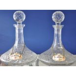 A pair of cut glass ships decanters and stoppers hung Harmersley porcelain labels,