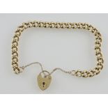 A heavy 9ct yellow gold curblink bracelet with padlock clasp,