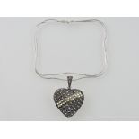 A large marcasite set heart shaped pendant, on a fine link chain stamped 925.