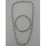 A 9 carat white gold twisted Singapore chain necklace, together with a matching bracelet, the clasps