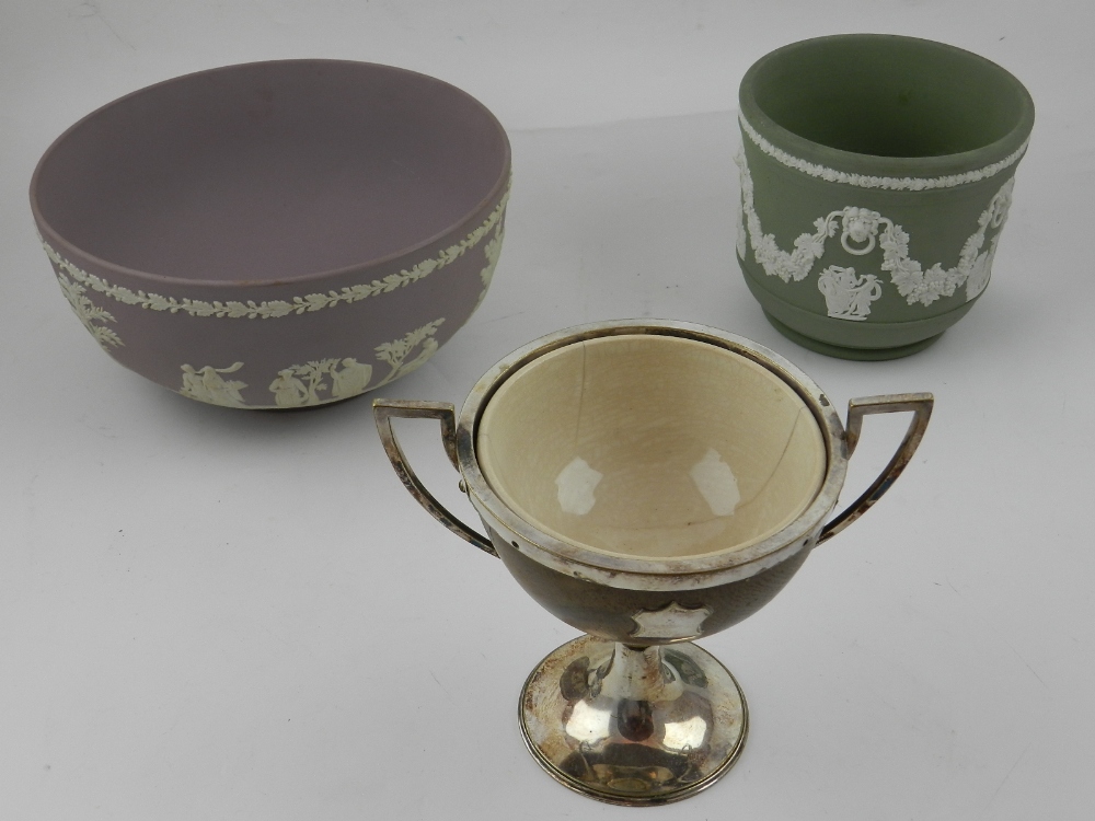 A cream Minton bowl set within a wooden and white metal cup,