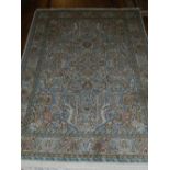 A Qum rug, having floral and foliate styled centre, multi bordered and fringed. L.220cm W.