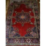 A Persian red ground Tabriz rug, having floral centred  medallion. L.177cm W.123cm