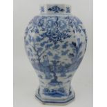 An early 20th century Dutch blue and white Delft pottery inverted baluster vase, decorated with